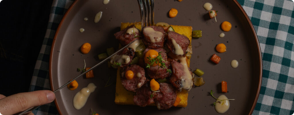 A Beautifully Plated Gourmet Dish Featuring Vibrant Vegetables And A Succulent Protein Centerpiece On A Stylish Table. (1)